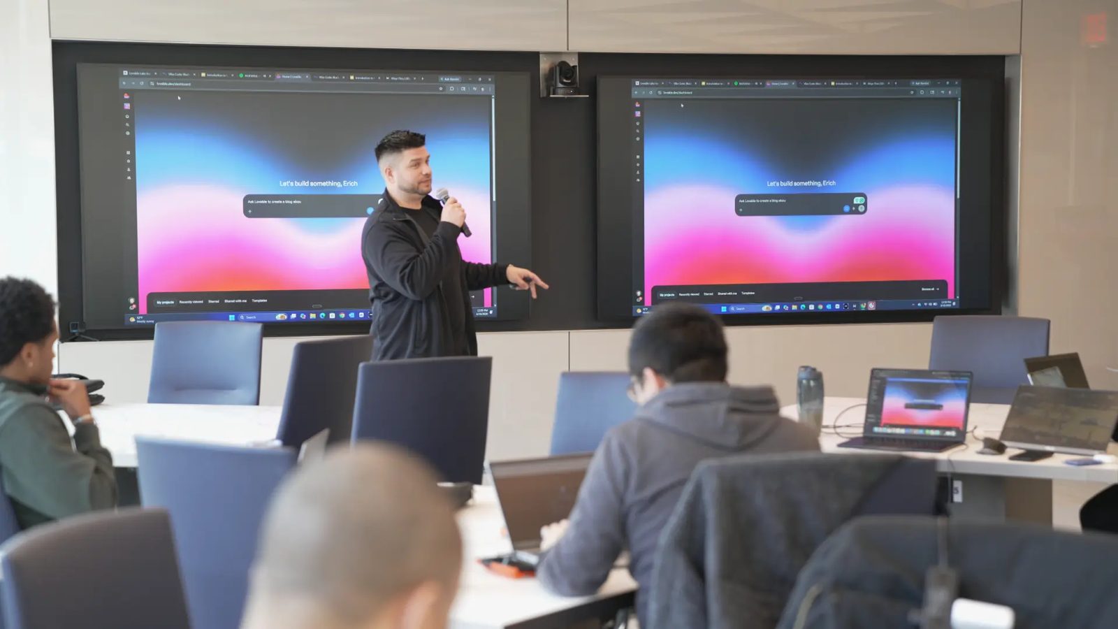 Live demonstration of the Lovable dashboard shown on two large wall displays