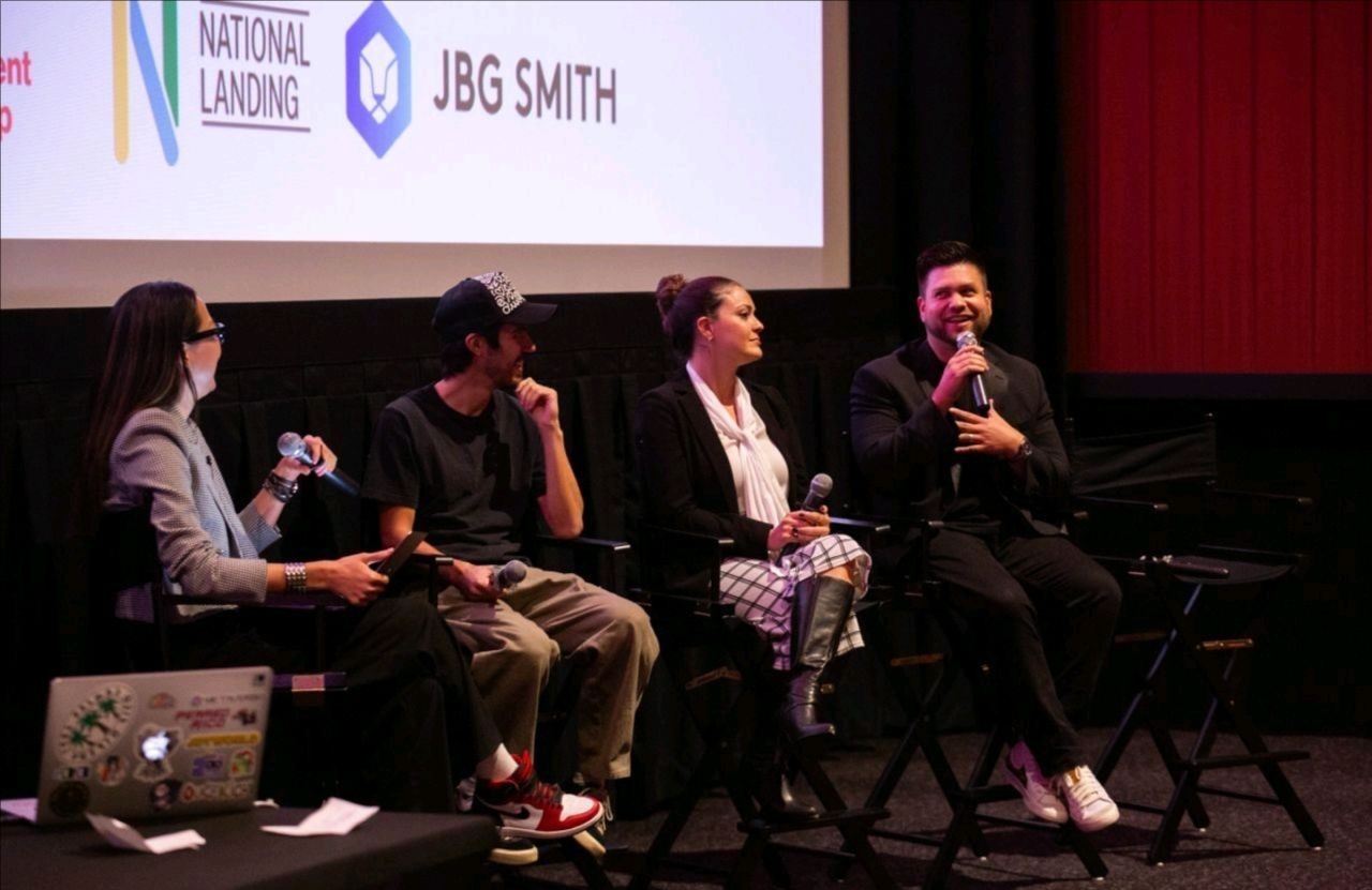 Four panelists seated on stage during a panel discussion